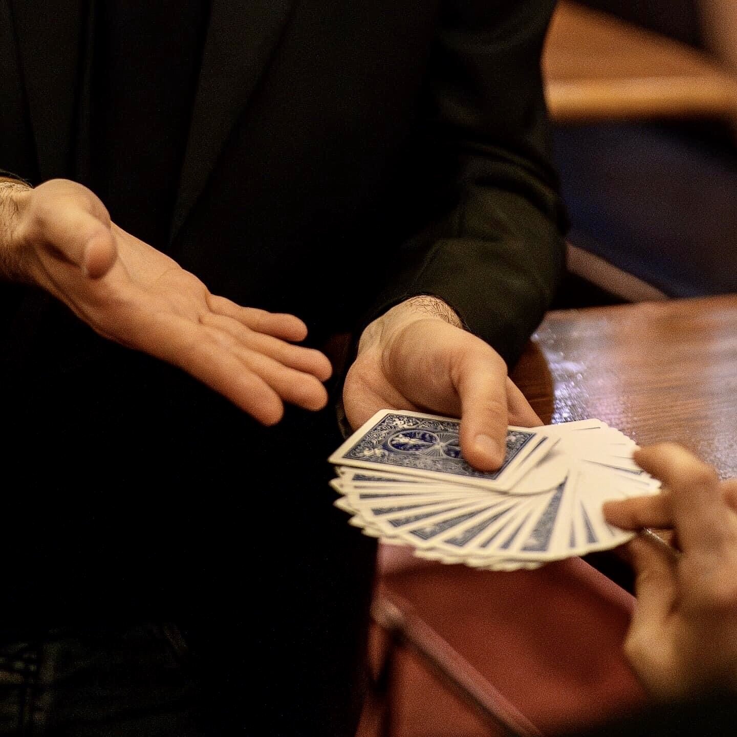 Simuan letting the audience pick a card from his hands.